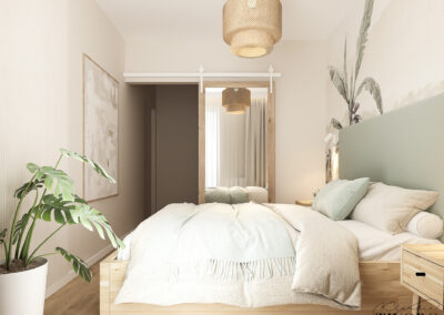 Sypialnia w stylu boho z drzwiami przesuwnymi typu barn door, drewnianymi meblami i roślinami.